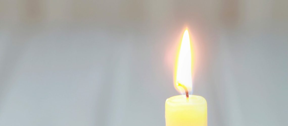 Yellow single candle, copy space.