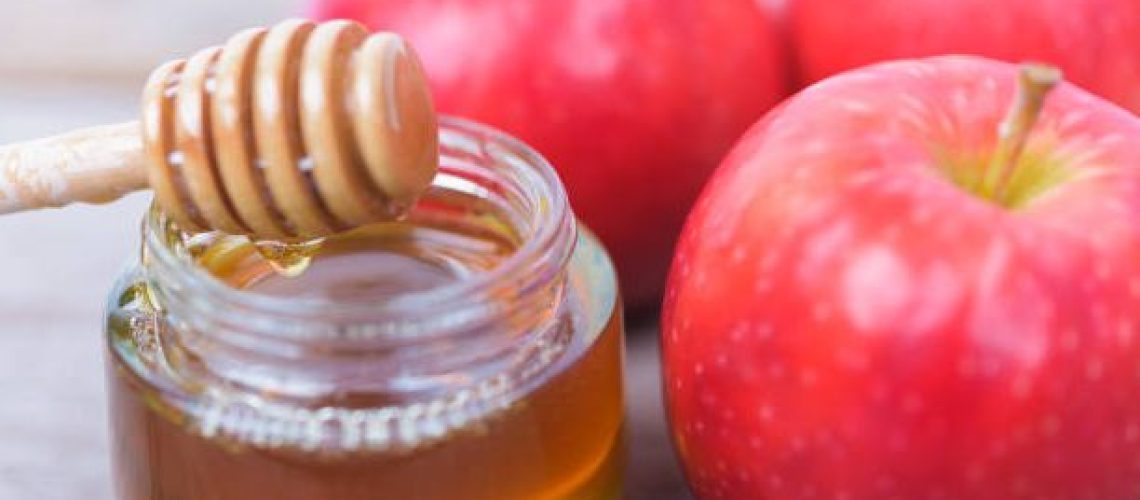 Jewish holiday, Apples Rosh Hashanah on the photo have honey in jar have red apples on wooden