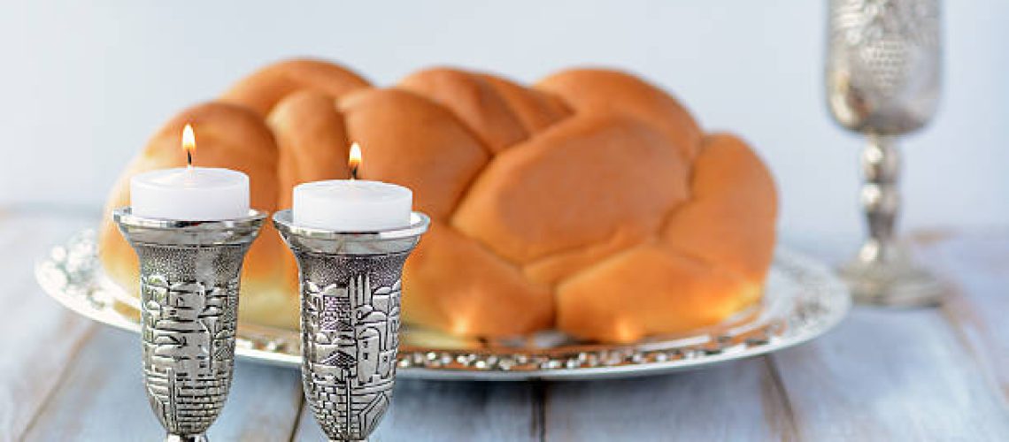 Shabbat candles with Challah bread and wine cup