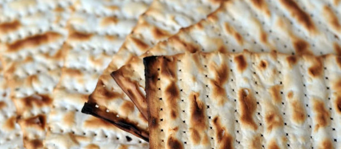 Matzo for Jewish Holiday Passover, an unleavened flatbread part of Jewish cuisine of Passover festival. Food background and texture