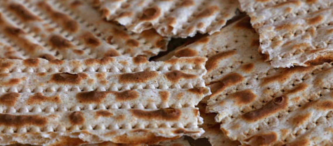 Close up square pieces of matzo flatbread crackers, traditional Jewish crispbread