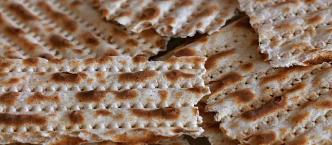 Close up square pieces of matzo flatbread crackers, traditional Jewish crispbread